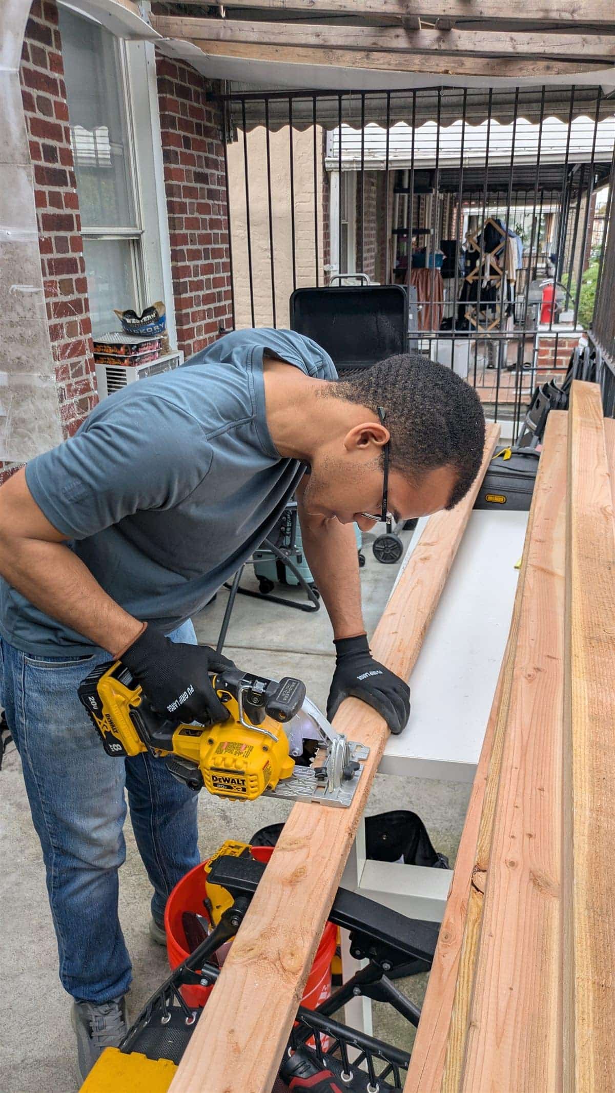 A team member cutting lumber for a custom sukkah build