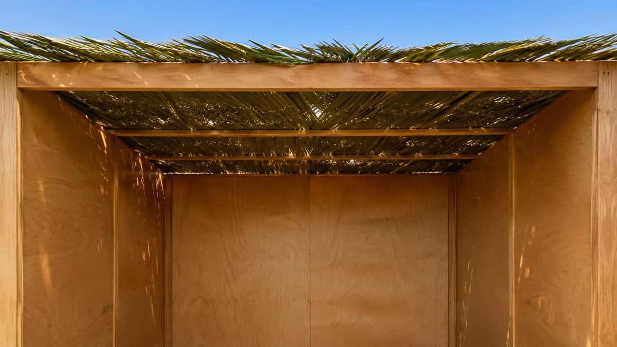 A wooden sukkah with bamboo schach