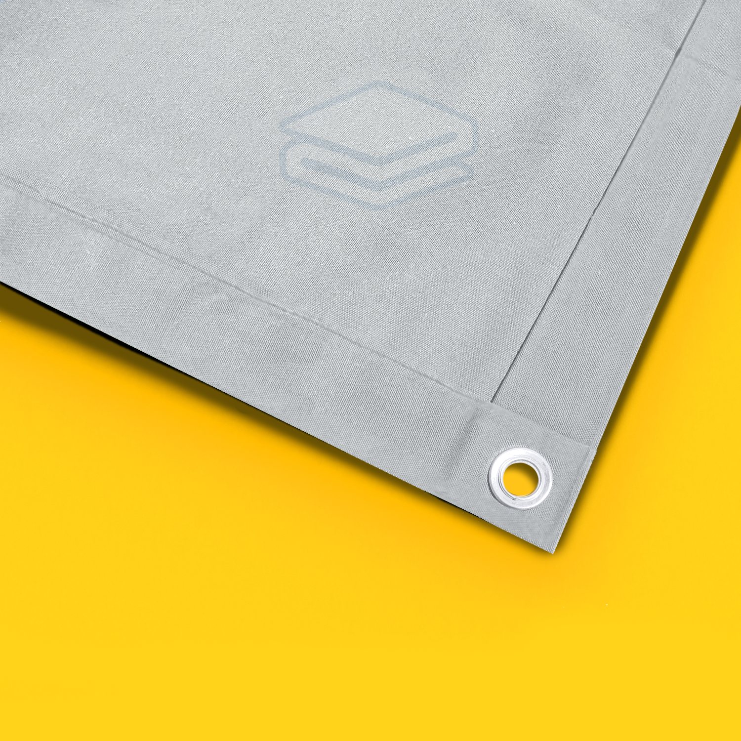 Close view of reinforced canvas with stitched hems and a metal grommet