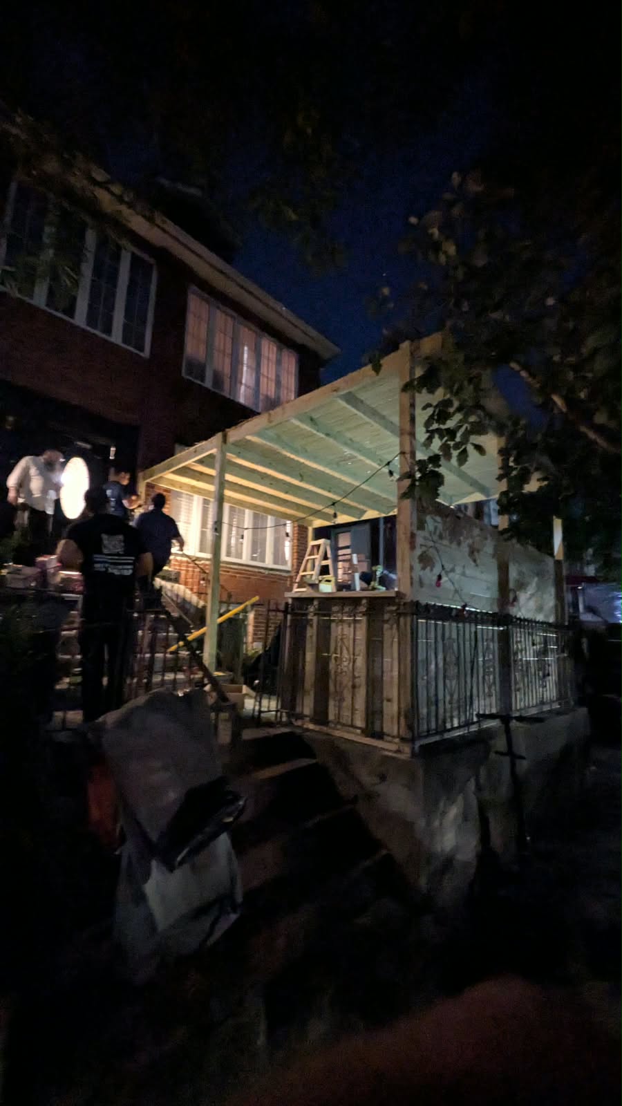Street view of the lighted front-yard wood pergola