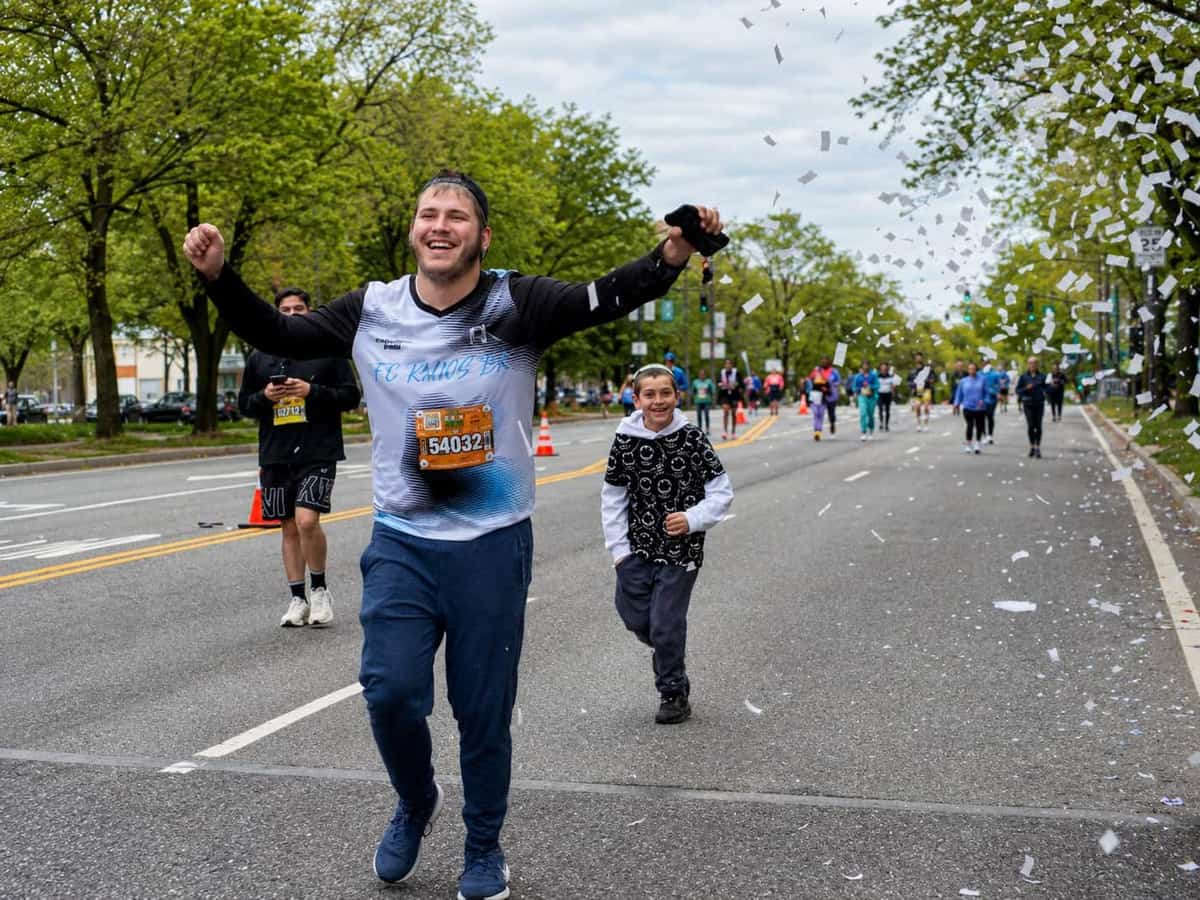 Benyamin smiling while running in a community race